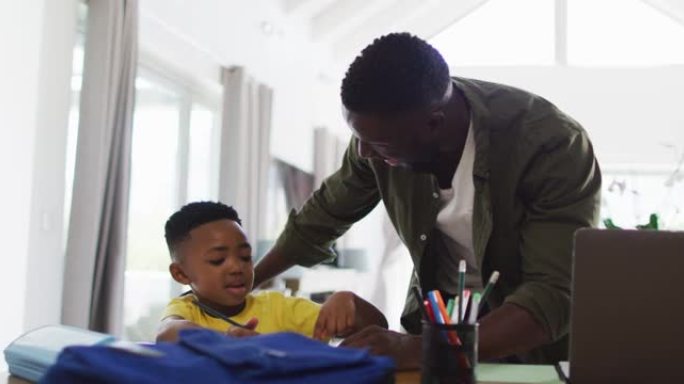 非裔美国人父子一起做作业和使用笔记本电脑
