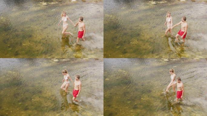 高加索夫妇在山上旅行时玩得很开心，穿着泳衣走进去