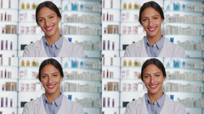 一位年轻的女药剂师顾问的肖像在一家药店的相机里微笑着。