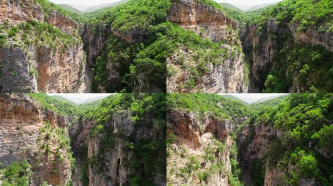 飞越长满灌木丛和树木的岩石峡谷。阿尔巴尼亚的Langarica峡谷，靠近Kadiut桥