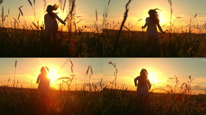 日落时在草地中央奔跑的小女孩的超级SLO MO剪影