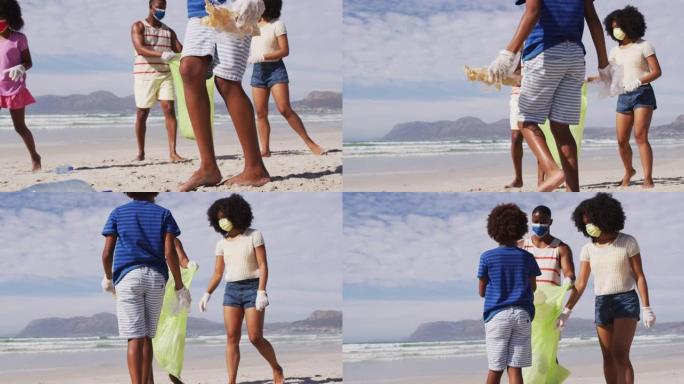 有两个孩子戴着口罩的非裔美国父母从海滩收集垃圾