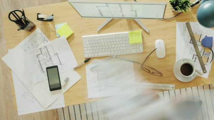 缩小专家在办公桌上处理建筑蓝图并使用计算机打字的时间间隔
