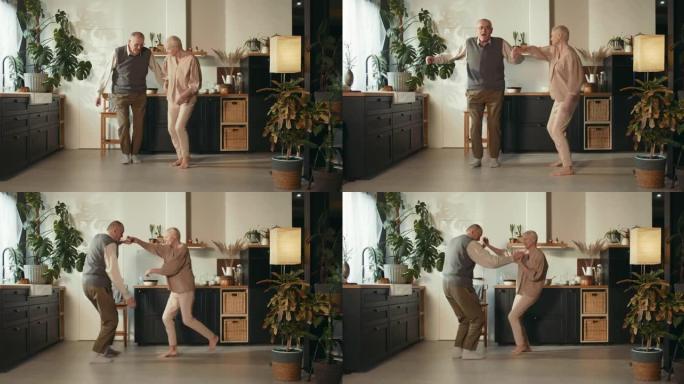 可爱的快乐的70年代老年夫妇在舒适的家庭厨房里一起跳舞，享受婚姻关系。
