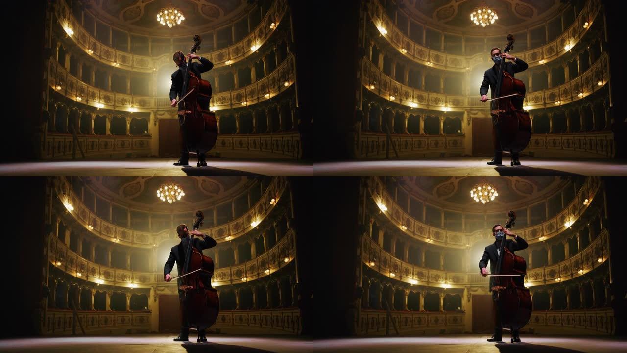 戴着保护性医用口罩的男性大提琴手的电影镜头正在独奏大提琴