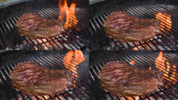 美味的纽约带牛排，放在带有火焰的老式木炭烤架上