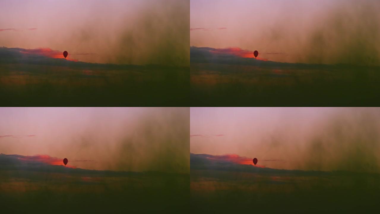 日落时分，在宁静的天空中剪影热气球