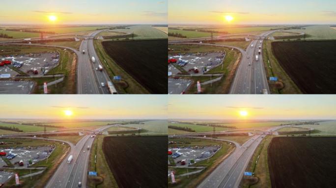 日落时分美丽农田多车道公路和道路交叉口航拍视频