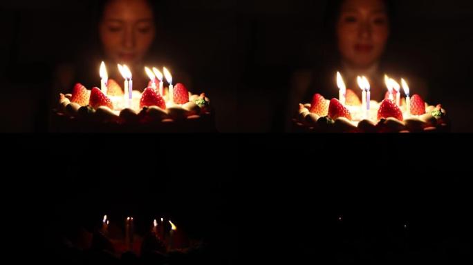 妇女在生日蛋糕上吹蜡烛