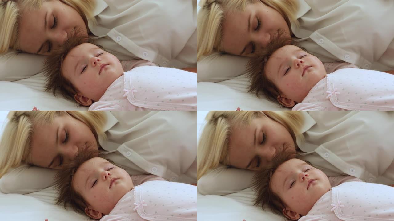 轻松平静的昏昏欲睡的妈妈和婴儿躺在白色床单上
