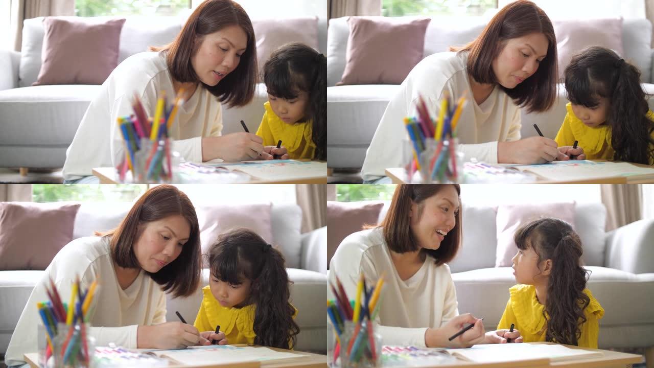 母亲在家客厅教小女孩画画