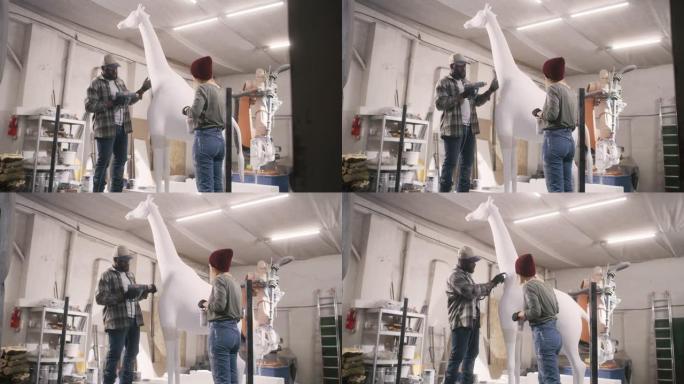 多元化的工匠一起制作长颈鹿雕像