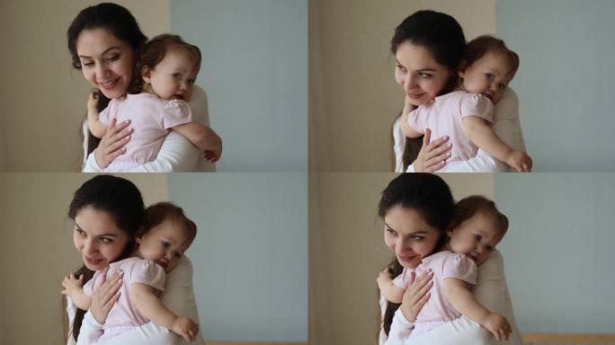 慈爱的母亲拥抱她可爱的女婴