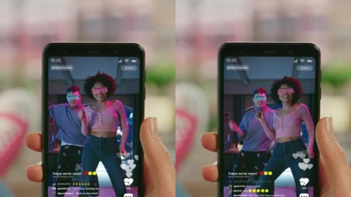 垂直POV第一人称手持智能手机使用社交媒体应用程序，观看现场视频时尚的人跳舞。模拟社交媒体视频共享移