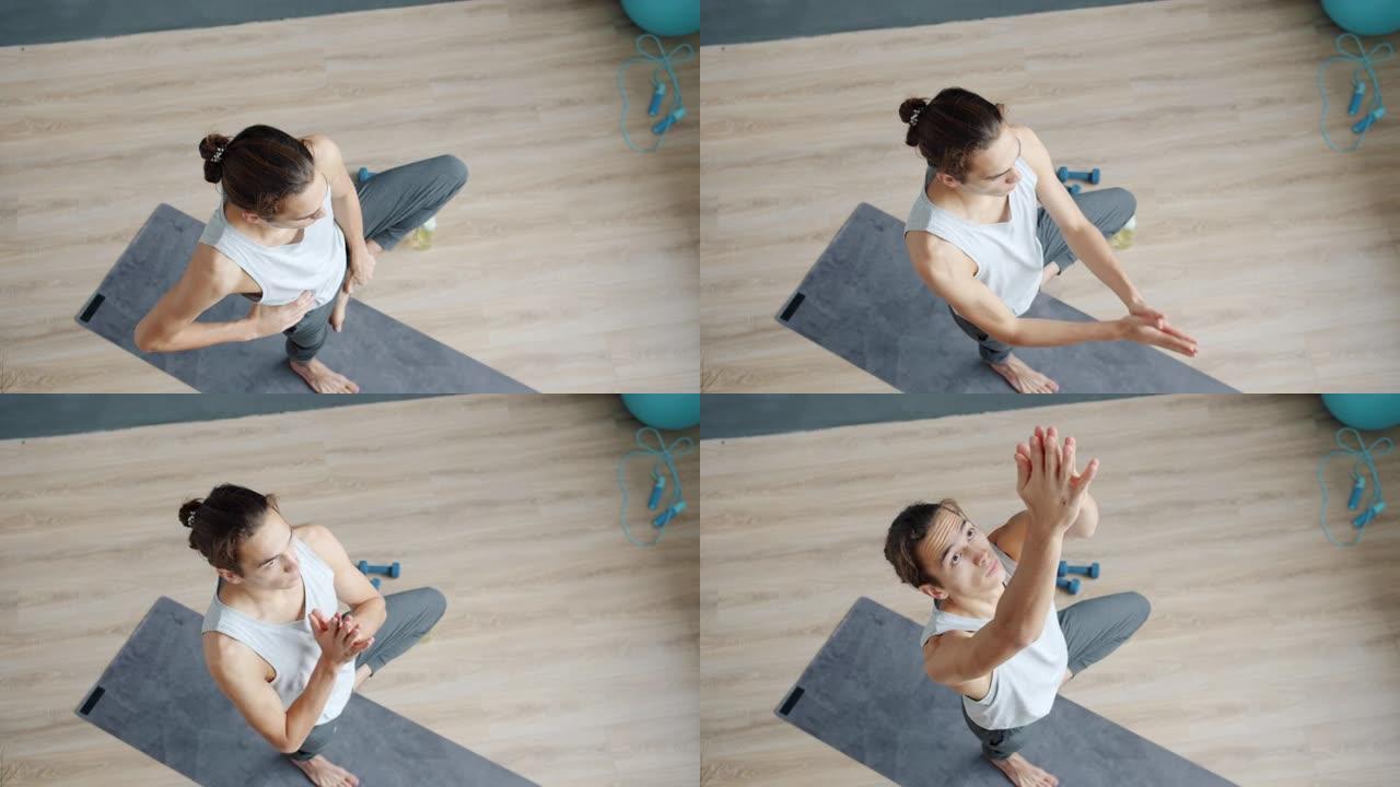 瑜伽工作室里年轻人训练的俯视图，独自享受体育锻炼。
