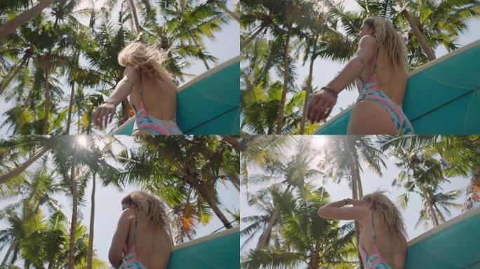 美丽的女人在热带岛屿冲浪板上行走穿着比基尼的女孩在夏季旅行假期享受夏季户外4k