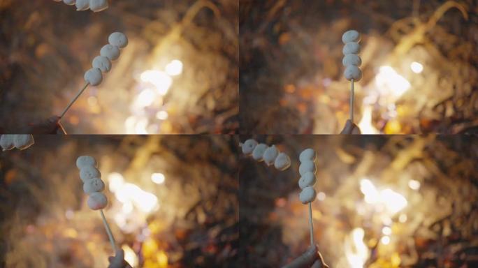 两次在篝火上拍摄棉花糖棒的SLOMO镜头