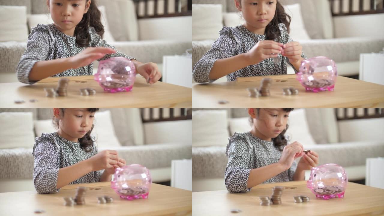女孩投入金钱硬币为未来保存粉红色的小猪