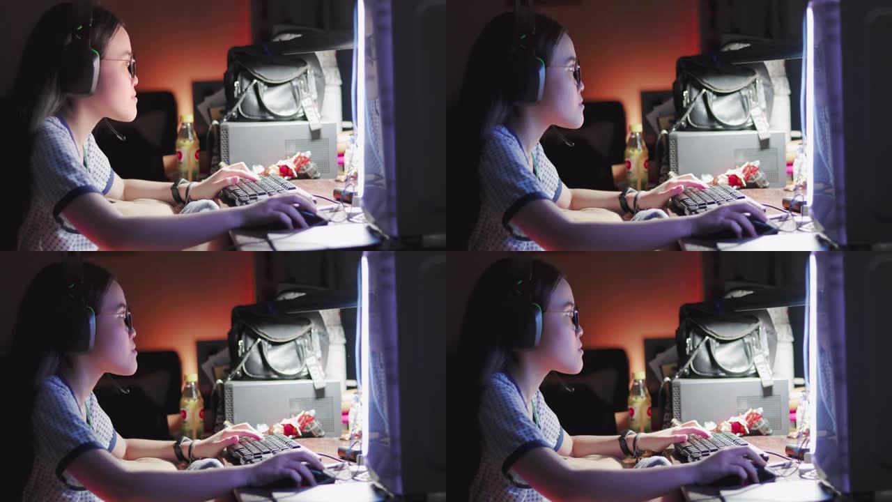 晚上在电脑上玩在线多人游戏的女孩玩家
