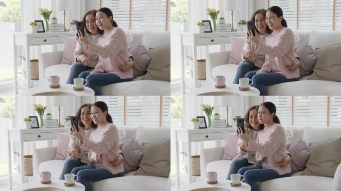 亚洲家庭老年老妇人平板手机视频通话屏幕