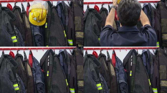 消防员在消防局储藏室中抓住头盔