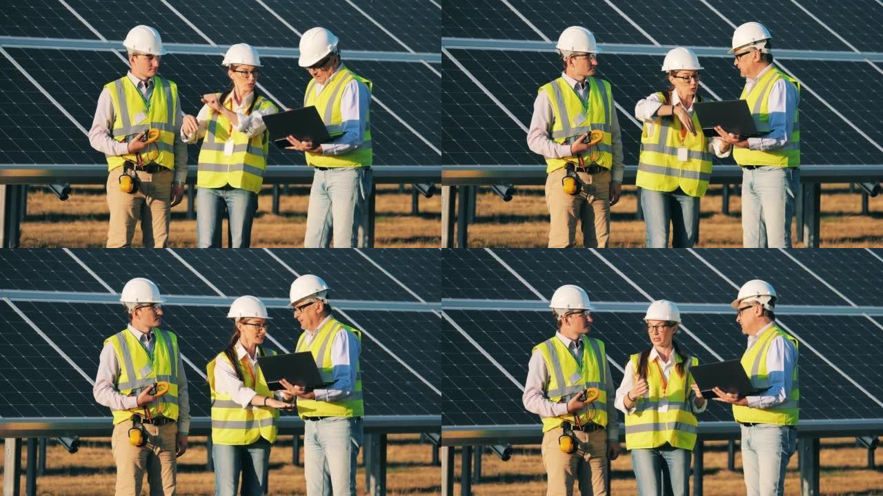 工程师们正在讨论太阳能能量学的一个项目。可再生能源、太阳能发电厂、绿色电力概念。