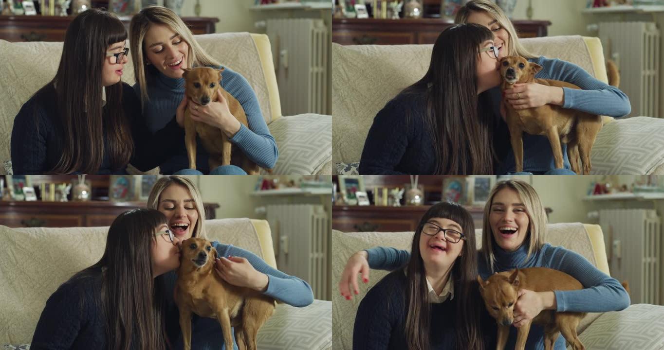 真实的照片，快乐的年轻女子与患有唐氏综合症的妹妹和他们的狗在家里玩得开心，在镜头前微笑。爱的概念，家