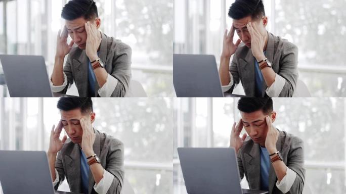 亚洲商人头痛，笔记本电脑和疲惫的脸在营销公司的沟通办公室。东京网络数字营销机构的人，计算机和心理健康