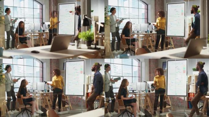 兴奋的营销经理在创意办公室会议室领导团队会议。自信的多民族女性在数字白板显示器上展示项目计划演示。