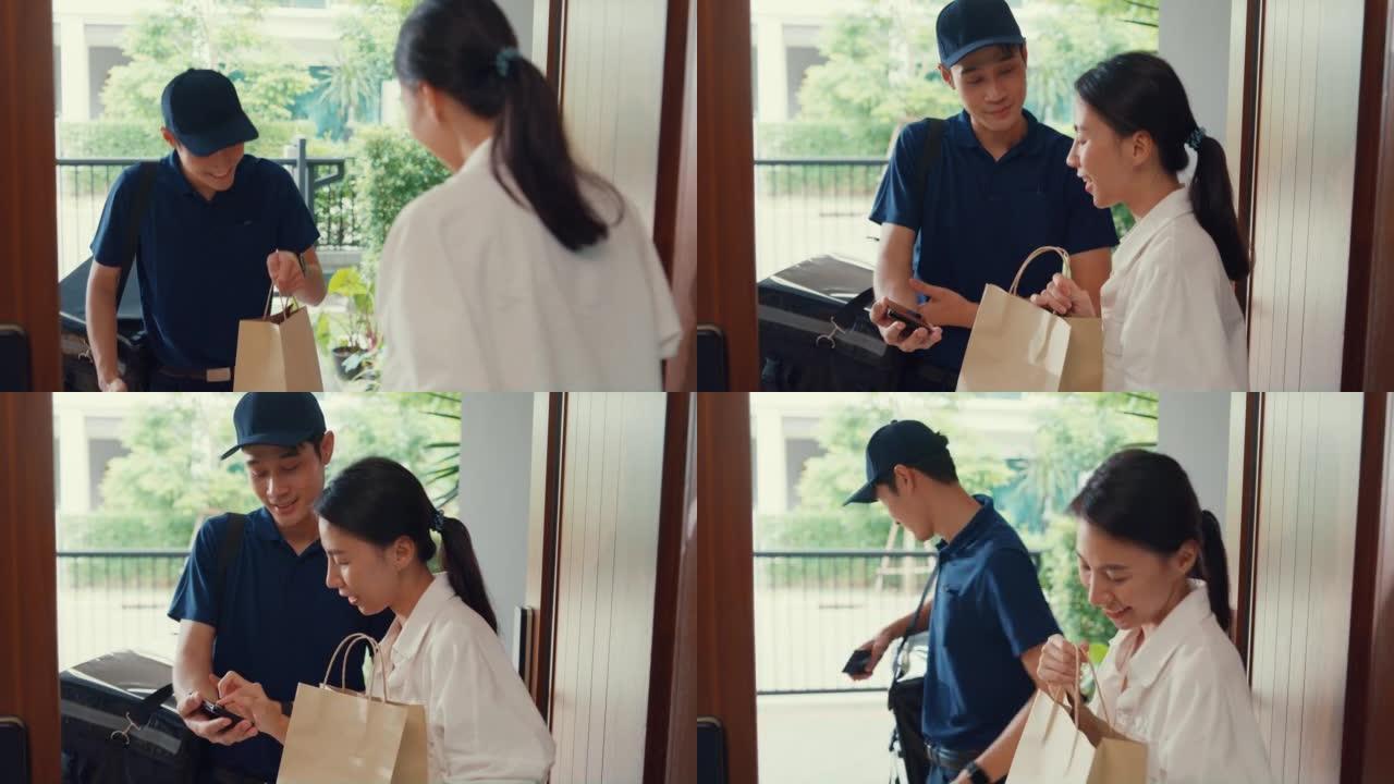 年轻的亚洲送货员穿着蓝色海军制服敲门送货上门杂货店网上购物给门前的女顾客，女人在家里接受纸袋。