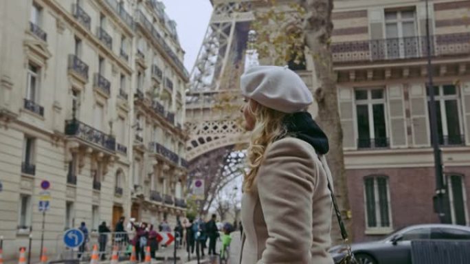 SLO MO法国女人沿着埃菲尔铁塔走在街上