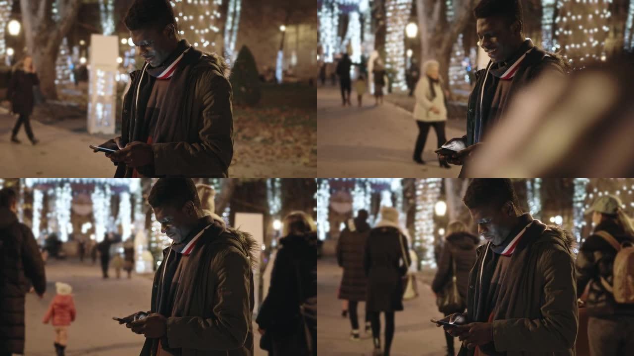 非裔美国男子在街上使用手机