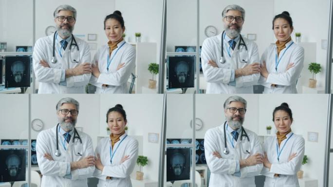 穿着制服的自信医生专业人员站在办公室微笑着看着现代诊所的相机。