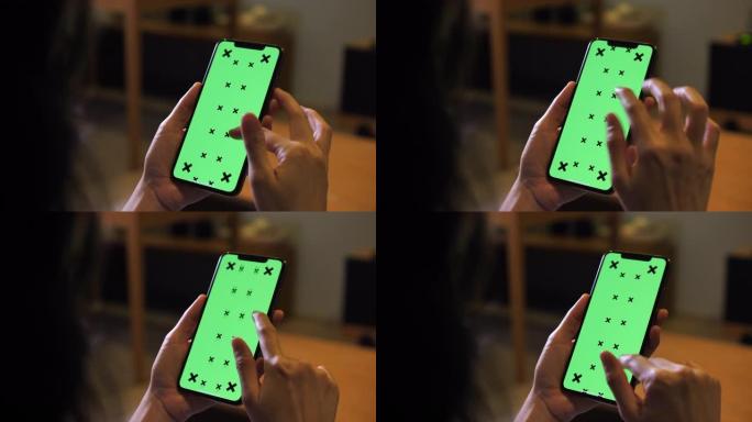使用智能手机绿屏的特写女性
