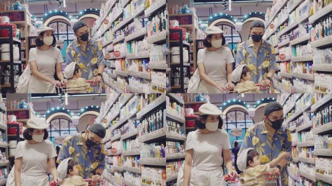 戴着防护口罩的家庭在超市购物。