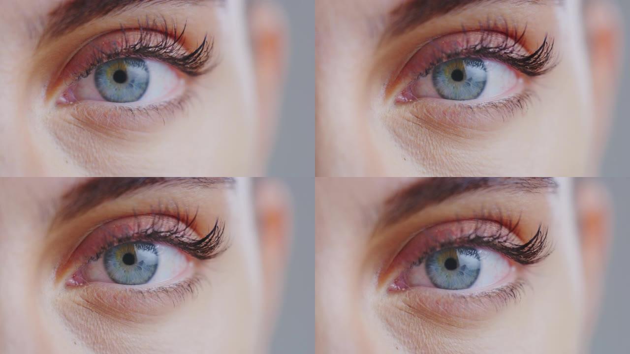 女性蓝眼睛的慢动作微距特写，完美的自然妆容，在相机中闪烁。