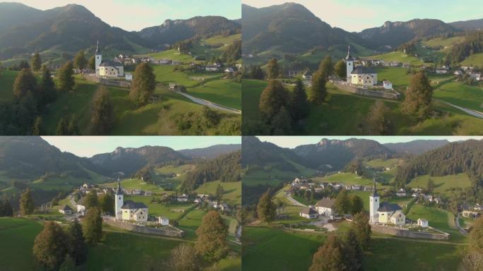 无人机: 在俯瞰乡村的山顶上的教堂和墓地周围飞行
