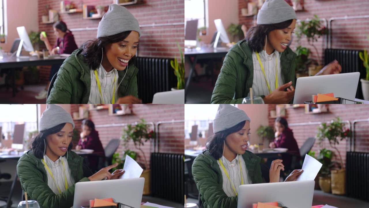 营销和广告员工通过笔记本电脑进行视频通话，在在线会议上进行交流和交谈。黑人妇女在办公室里用纸在虚拟会