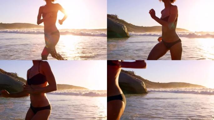 4k视频片段，一个无法识别的女人在日落时独自在海滩上奔跑