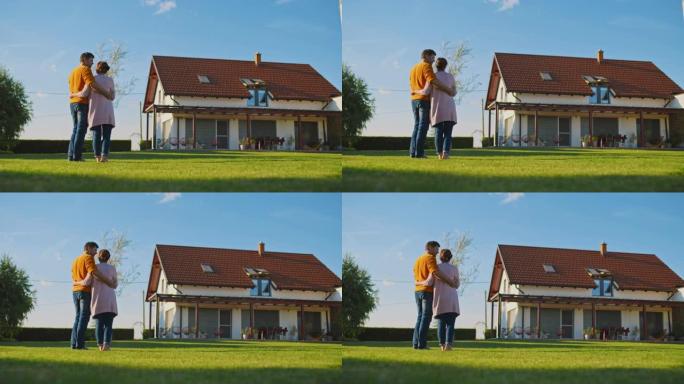 SLO MO夫妇在欣赏新房子时拥抱在一起