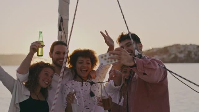 SLO MO一群朋友在日落时在船的甲板上自拍