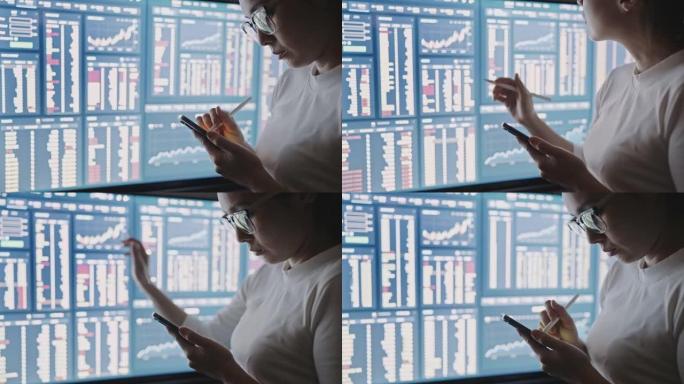 亚洲妇女分析数字，金融数字在大型电脑显示器或显示器上