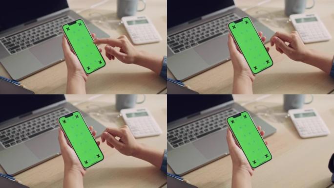 使用带有模拟绿屏的手机的特写女人