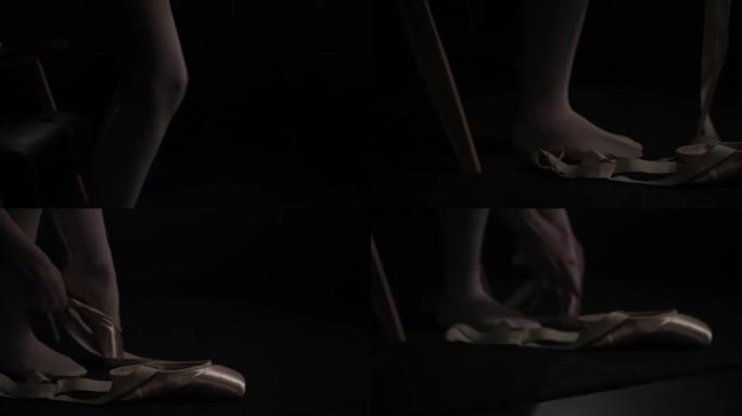 年轻的芭蕾舞女舞者在工作室穿上脚尖鞋