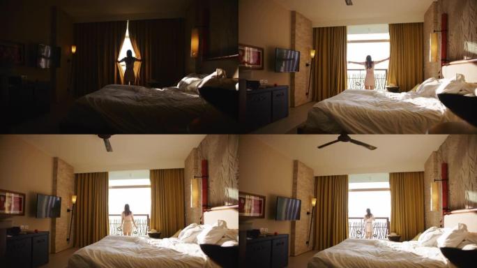 女人剪影早上在酒店打开窗帘