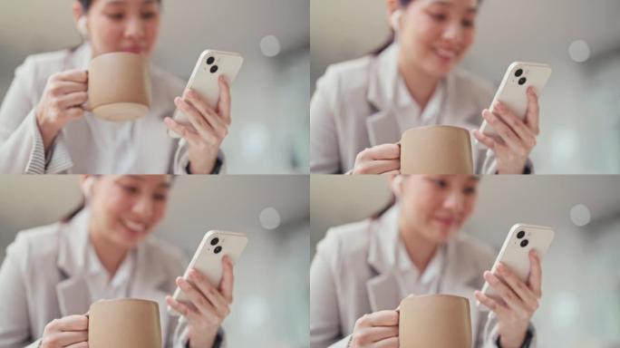 亚洲妇女拿着咖啡杯使用手机