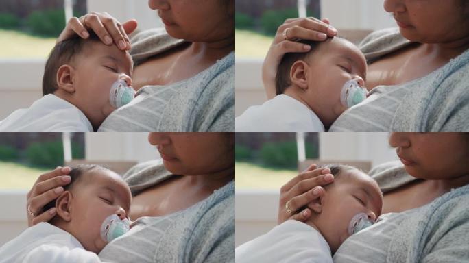 婴儿安静地睡在母亲的怀抱中慈爱的母亲抱着婴儿在家照顾困倦的幼儿4k