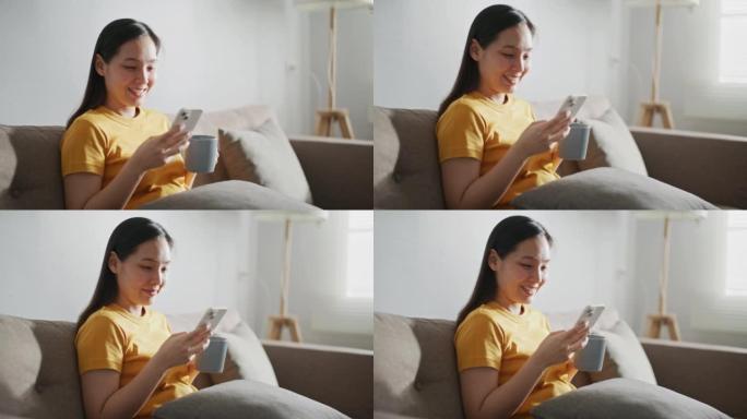 女人在沙发上使用智能手机