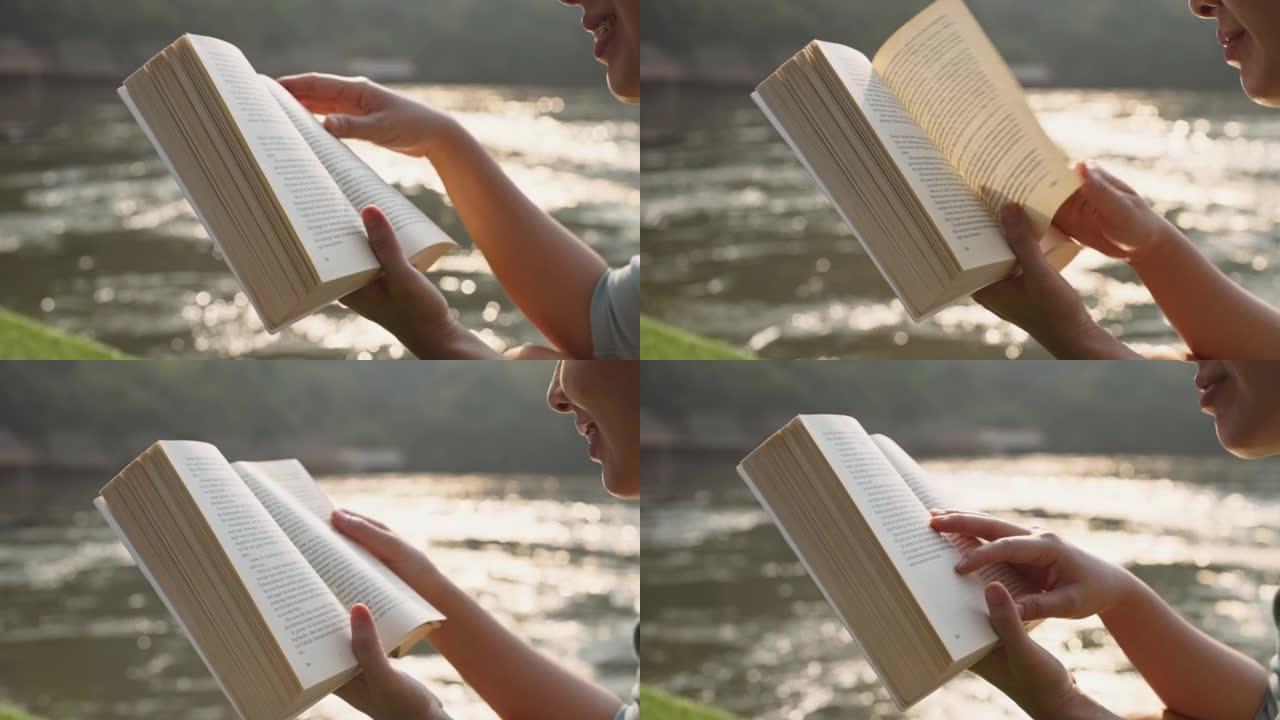 年轻女子在湖边看书放松
