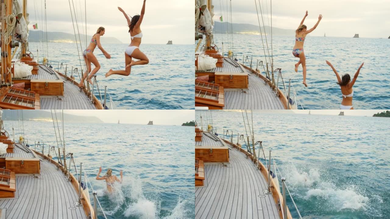 快乐的朋友们兴奋地从意大利周围航行的船上跳入大海。两个女人在度假时一起从船上跳入大海游泳。女人从船上